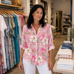 Alenne styling the pink Blush Blossom floral blouse with white trousers in the boutique